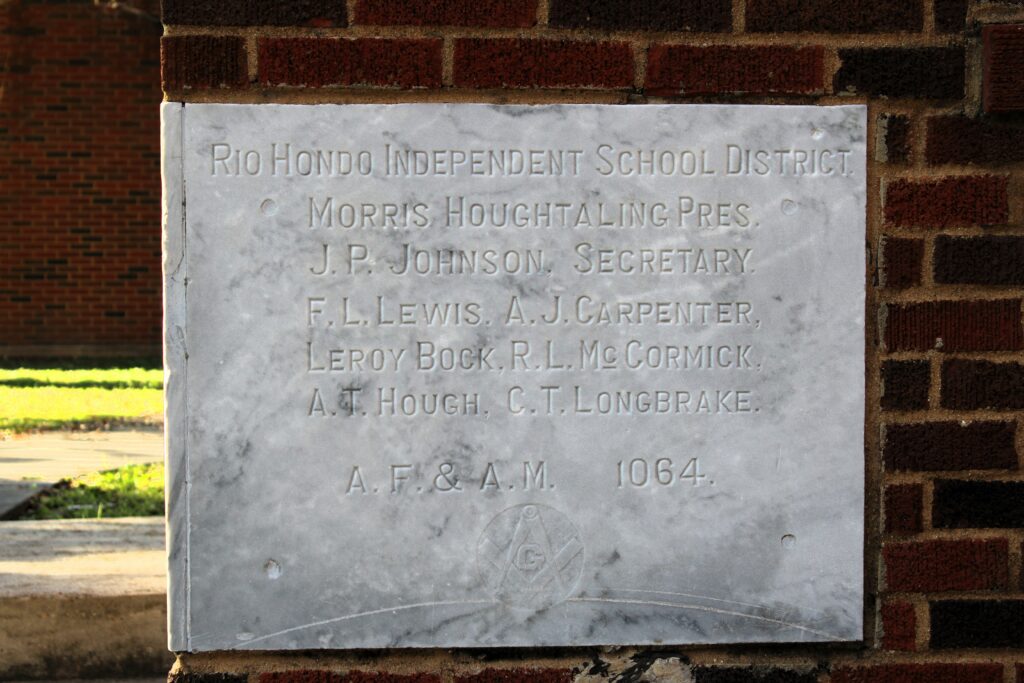 A cornerstone plaque recognizing the Rio Hondo ISD Board of Trustees that served during the construction of the Old High School, located south of the RHISD administration building.