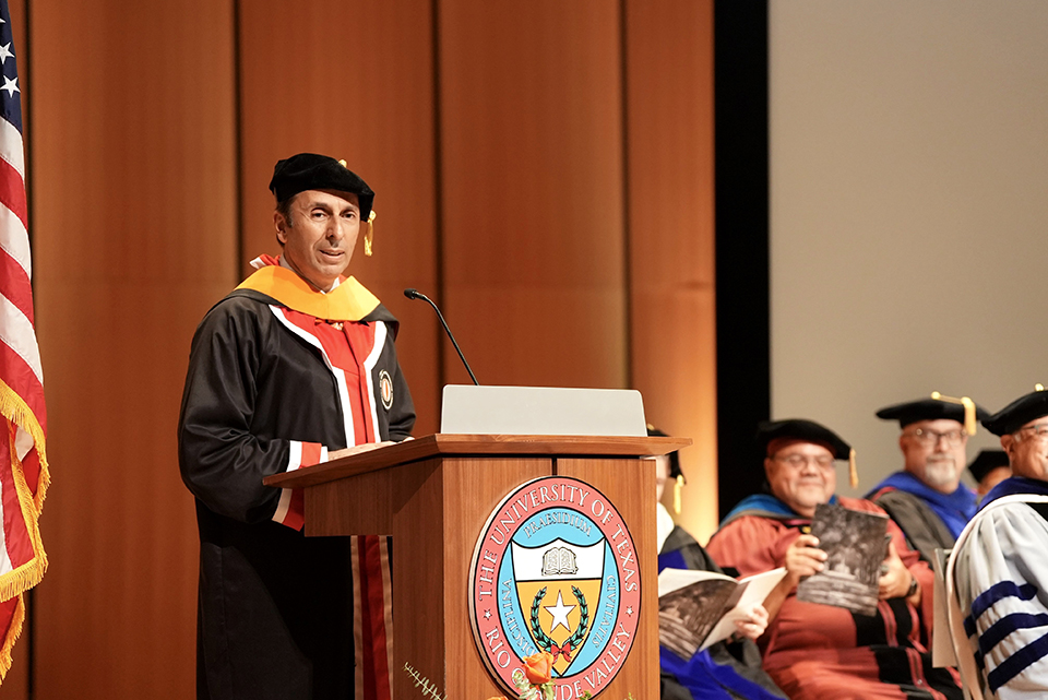 Dr. Can (John) Saygin, senior vice president for Research and dean of the Graduate College at UTRGV, addresses doctoral candidates during the hooding ceremony on May 8. The event celebrated doctoral candidates from four academic colleges, recognizing their academic achievements. (UTRGV Photo by Jesús Alférez)