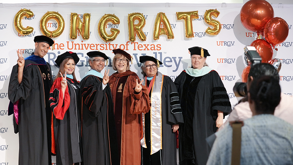 Candidates and faculty gathered at the reception following the doctoral hooding ceremony at the Performing Arts Complex, marking a moment of celebration. (UTRGV Photo by Jesús Alférez)